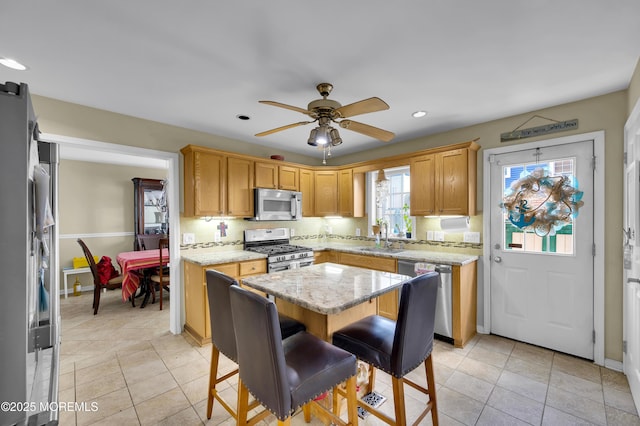 315 Shuster Ave, Ortley Beach, NJ 08751 - kitchen with appliances with stainless steel finishes, a ceiling fan, recessed lighting, light stone countertops, and light tile patterned floors