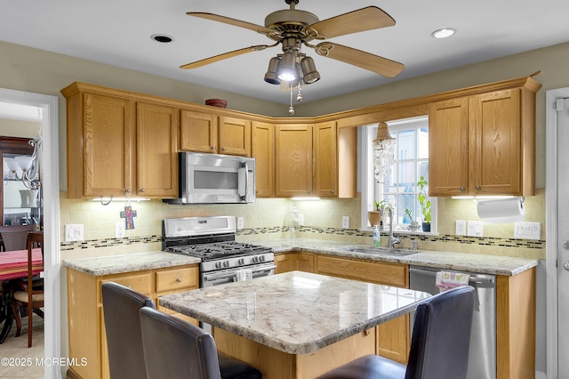 315 Shuster Ave, Ortley Beach, NJ 08751 - kitchen with appliances with stainless steel finishes, light stone counters, decorative backsplash, and recessed lighting