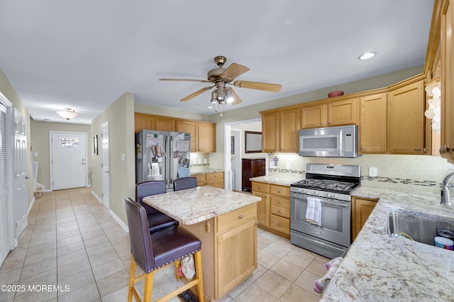 315 Shuster Ave, Ortley Beach, NJ 08751 - kitchen with stainless steel appliances, light tile patterned flooring, a kitchen island, decorative backsplash, and recessed lighting