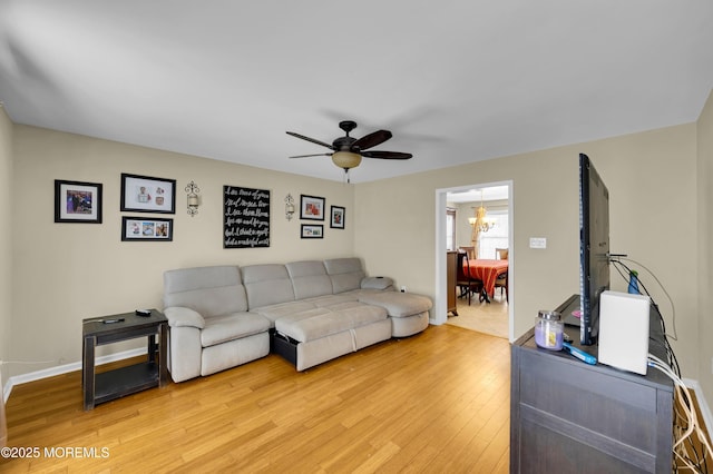 315 Shuster Ave, Ortley Beach, NJ 08751 - living room with light wood finished floors, ceiling fan, and a chandelier