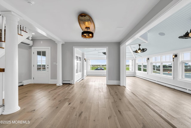 900 Ocean Ave, Bradley Beach, NJ 07720 - unfurnished living room with decorative columns, a wall mounted air conditioner, baseboard heating, and healthy amount of natural light