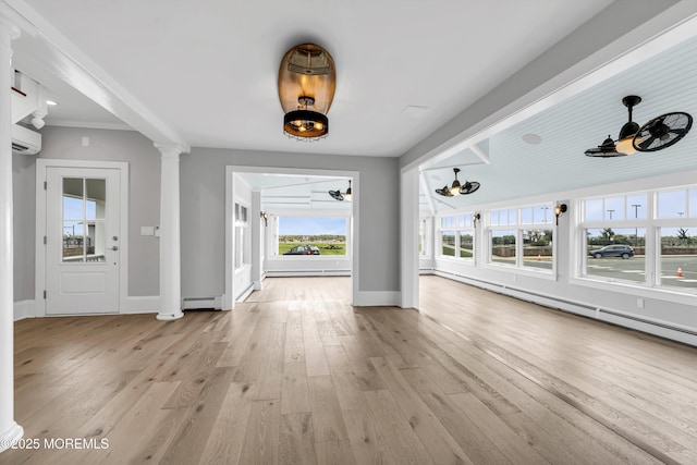 900 Ocean Ave, Bradley Beach, NJ 07720 - unfurnished living room with a wall unit AC, light wood-style flooring, ornate columns, and a baseboard heating unit