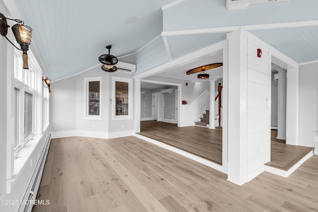 900 Ocean Ave, Bradley Beach, NJ 07720 - unfurnished living room featuring a wall unit AC, a ceiling fan, light wood-style flooring, a baseboard radiator, and stairs