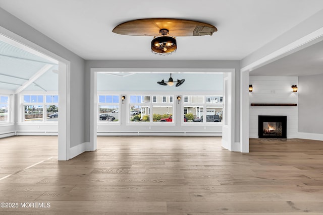 900 Ocean Ave, Bradley Beach, NJ 07720 - unfurnished living room featuring wood finished floors and a glass covered fireplace