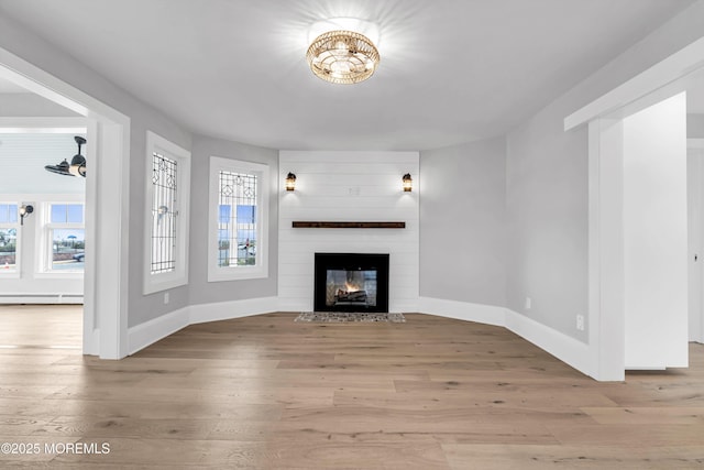 900 Ocean Ave, Bradley Beach, NJ 07720 - unfurnished living room with a baseboard heating unit, wood finished floors, and a large fireplace