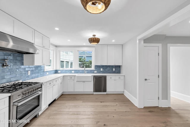 900 Ocean Ave, Bradley Beach, NJ 07720 - kitchen with appliances with stainless steel finishes, light countertops, tasteful backsplash, white cabinetry, and recessed lighting