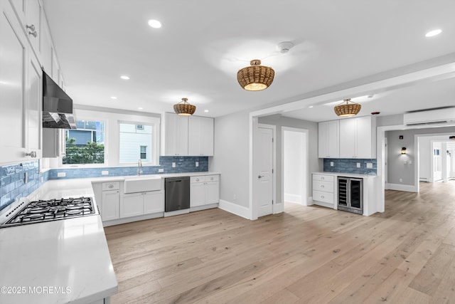 900 Ocean Ave, Bradley Beach, NJ 07720 - kitchen featuring wine cooler, stainless steel appliances, a wall mounted AC, range hood, and decorative backsplash
