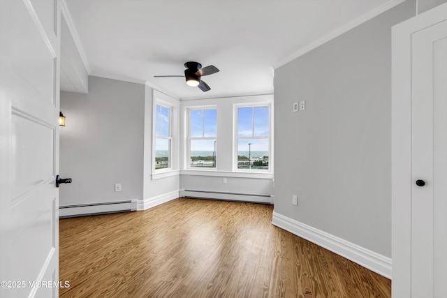 900 Ocean Ave, Bradley Beach, NJ 07720 - spare room featuring a baseboard heating unit, baseboard heating, ornamental molding, a ceiling fan, and wood finished floors
