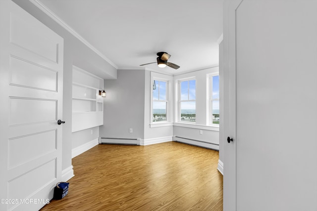 900 Ocean Ave, Bradley Beach, NJ 07720 - spare room featuring a baseboard heating unit, crown molding, a ceiling fan, and wood finished floors