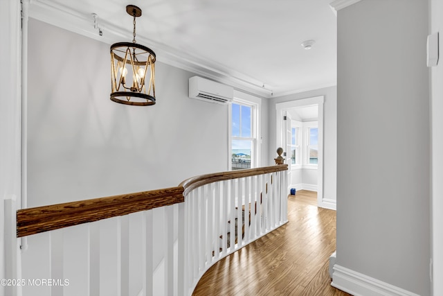 900 Ocean Ave, Bradley Beach, NJ 07720 - corridor featuring a wall unit AC, a chandelier, ornamental molding, wood finished floors, and an upstairs landing