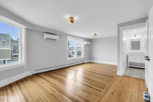 900 Ocean Ave, Bradley Beach, NJ 07720 - empty room featuring baseboard heating, a wall mounted AC, and light wood-style floors