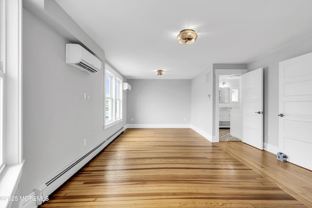 900 Ocean Ave, Bradley Beach, NJ 07720 - empty room with a wall mounted air conditioner, a baseboard radiator, light wood-type flooring, and plenty of natural light