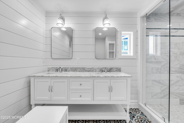 900 Ocean Ave, Bradley Beach, NJ 07720 - bathroom featuring double vanity, tiled shower, and wood walls