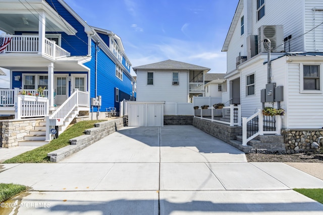 900 Ocean Ave, Bradley Beach, NJ 07720 - view of side of home with a porch, a balcony, and concrete driveway