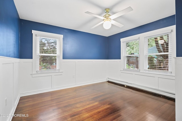 51 Burdge Ave, Brick, NJ 08724 - empty room with a baseboard heating unit, wainscoting, ceiling fan, wood finished floors, and a decorative wall