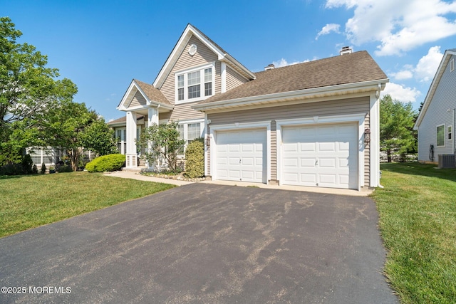 98 Mirage Blvd, Barnegat, NJ 08005 - view of front of house featuring driveway, a front yard, a chimney, and an attached garage