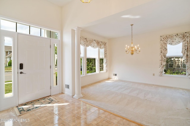 98 Mirage Blvd, Barnegat, NJ 08005 - entryway featuring ornate columns, a chandelier, carpet flooring, and tile patterned flooring