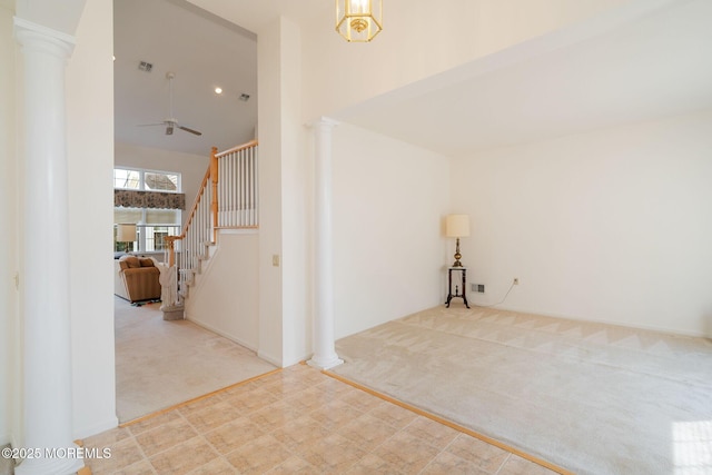 98 Mirage Blvd, Barnegat, NJ 08005 - empty room featuring decorative columns, carpet floors, a ceiling fan, stairs, and high vaulted ceiling