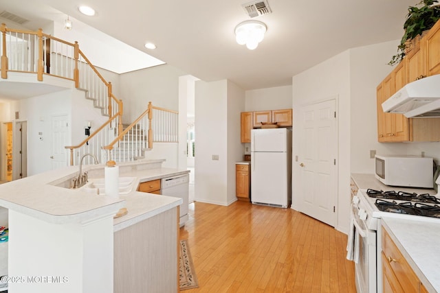 98 Mirage Blvd, Barnegat, NJ 08005 - kitchen with white appliances, under cabinet range hood, light wood finished floors, light countertops, and a kitchen island with sink