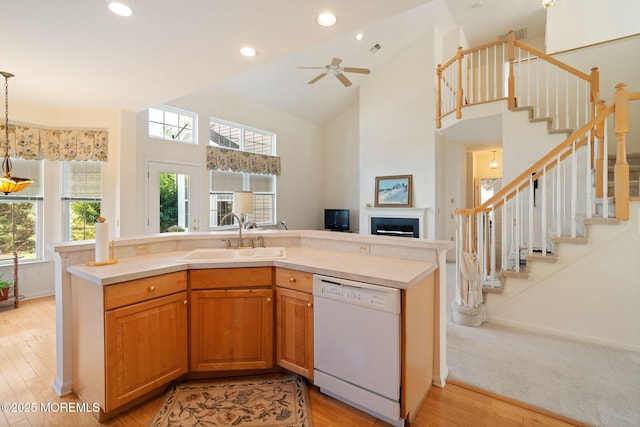 98 Mirage Blvd, Barnegat, NJ 08005 - kitchen with white dishwasher, open floor plan, light countertops, a fireplace, and high vaulted ceiling