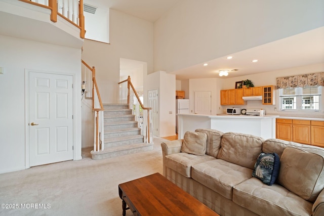 98 Mirage Blvd, Barnegat, NJ 08005 - living room featuring light colored carpet, a towering ceiling, stairs, and recessed lighting