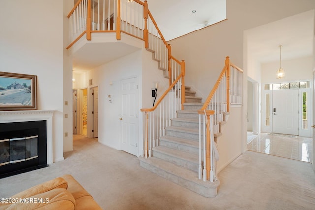 98 Mirage Blvd, Barnegat, NJ 08005 - foyer featuring a towering ceiling, stairs, carpet floors, and a fireplace with flush hearth