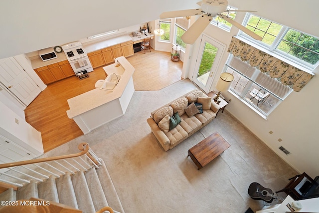 98 Mirage Blvd, Barnegat, NJ 08005 - living room with a high ceiling, a ceiling fan, and light wood-type flooring