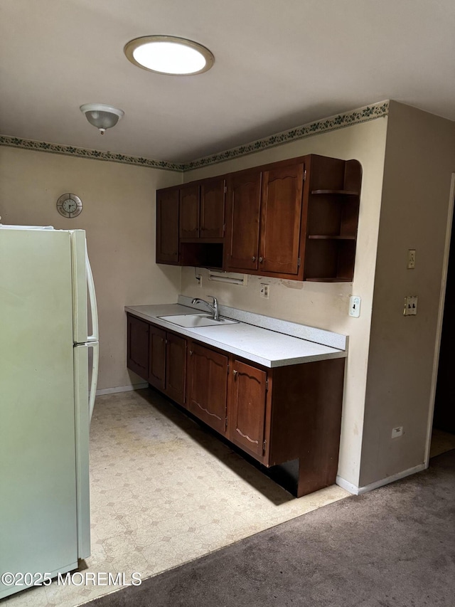474F Thornbury Ct, Lakewood, NJ 08701 - kitchen with freestanding refrigerator, open shelves, light countertops, light carpet, and dark brown cabinetry