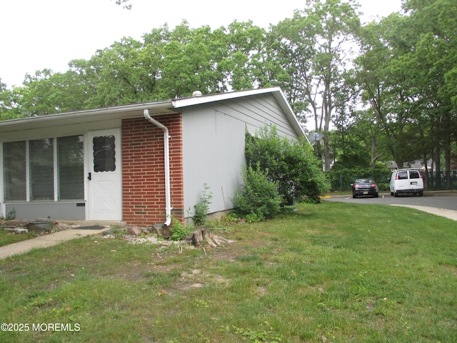 474F Thornbury Ct, Lakewood, NJ 08701 - view of property exterior featuring brick siding and a yard