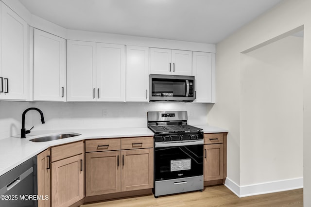 104 Dundee Ct, Aberdeen, NJ 07747 - kitchen with stainless steel appliances, light wood finished floors, light countertops, and white cabinets