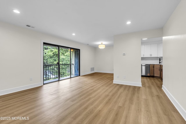 104 Dundee Ct, Aberdeen, NJ 07747 - unfurnished living room featuring light wood-style floors and recessed lighting