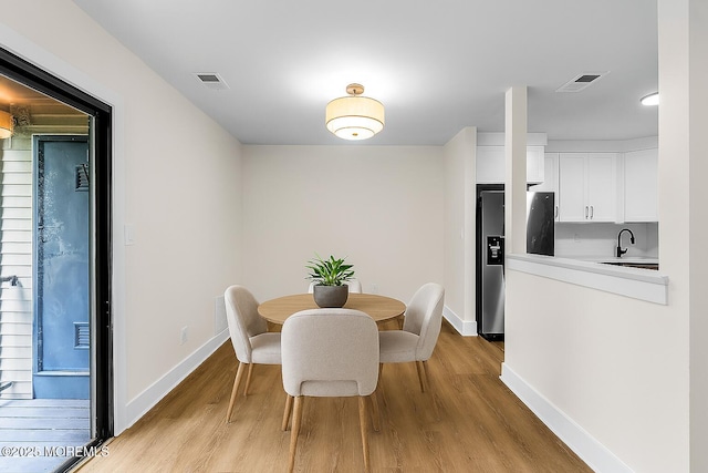 104 Dundee Ct, Aberdeen, NJ 07747 - dining room with light wood finished floors and baseboards
