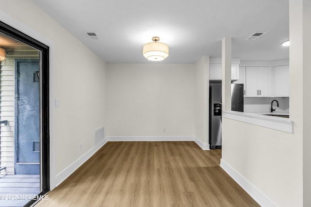 104 Dundee Ct, Aberdeen, NJ 07747 - unfurnished dining area featuring light wood-style flooring and a sink