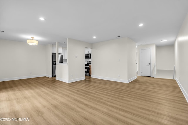 104 Dundee Ct, Aberdeen, NJ 07747 - unfurnished living room with light wood-style floors and recessed lighting