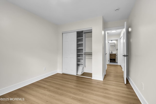 104 Dundee Ct, Aberdeen, NJ 07747 - unfurnished bedroom with light wood finished floors and a closet