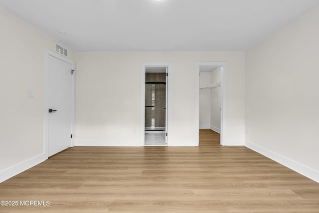 104 Dundee Ct, Aberdeen, NJ 07747 - unfurnished bedroom with a spacious closet and light wood-type flooring