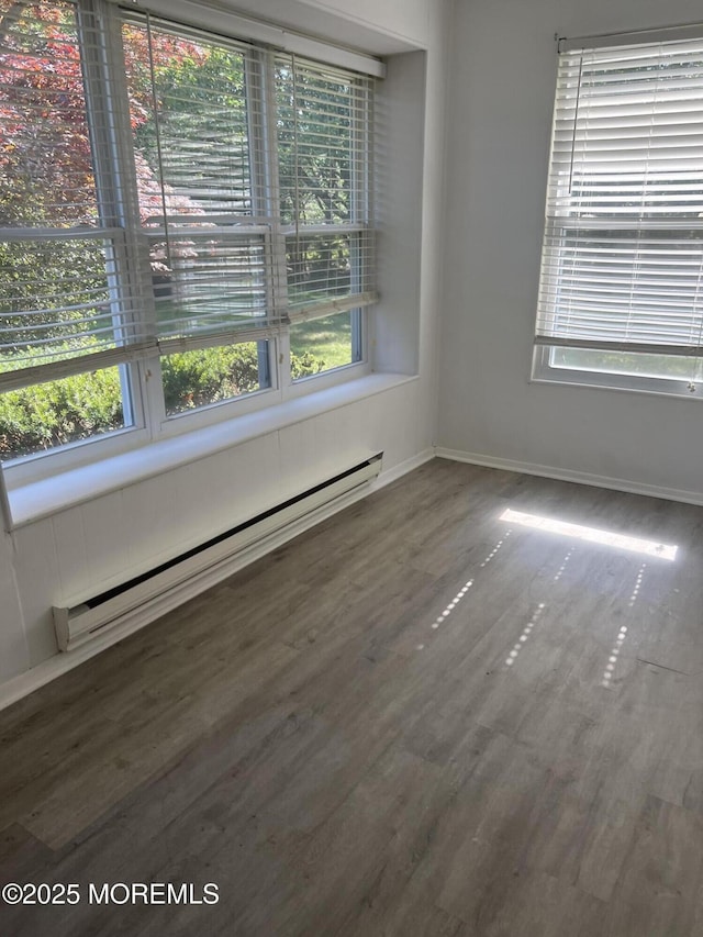 6D Potomac Ln, Manchester, NJ 08759 - spare room featuring a baseboard heating unit and wood finished floors