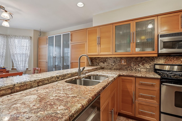 149 Jefferson Dr, Ocean Twp, NJ 07712 - kitchen with stainless steel appliances, light stone counters, decorative backsplash, glass insert cabinets, and recessed lighting