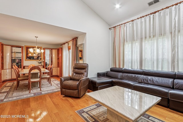 149 Jefferson Dr, Ocean Twp, NJ 07712 - living room with a chandelier, light wood-style flooring, and high vaulted ceiling