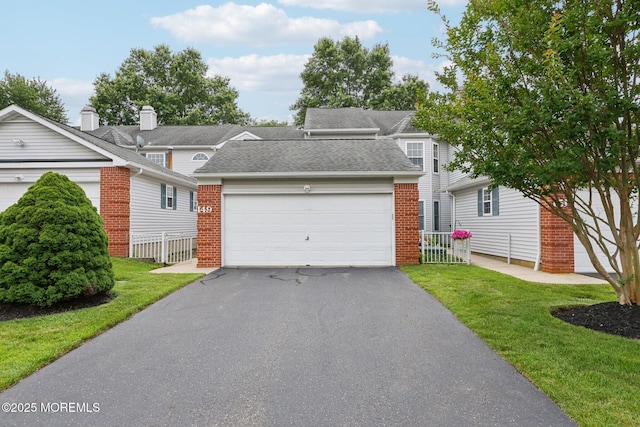 149 Jefferson Dr, Ocean Twp, NJ 07712 - traditional home featuring brick siding, a shingled roof, driveway, and an attached garage