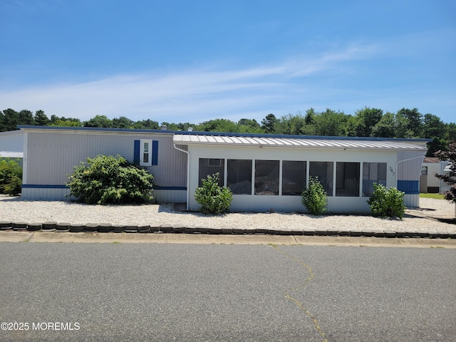 1881 Rte 37 Unit 347, Toms River, NJ 08757 - rear view of house featuring a standing seam roof, a metal roof, and a sunroom
