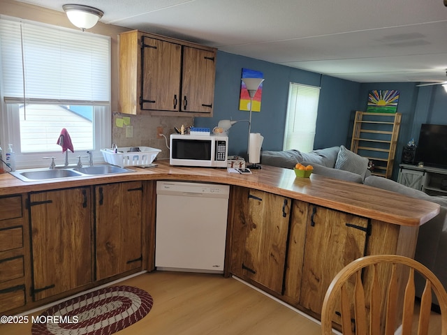 1881 Rte 37 Unit 347, Toms River, NJ 08757 - kitchen featuring white appliances, a peninsula, open floor plan, light wood-style flooring, and brown cabinets
