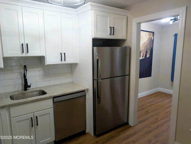 101 Begonia Ct, Jackson, NJ 08527 - kitchen with appliances with stainless steel finishes, decorative backsplash, dark wood-style flooring, and white cabinetry