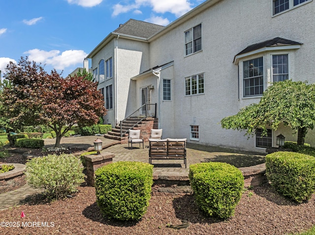 1 Hopkinson Ct, Marlboro, NJ 07746 - back of house featuring stucco siding and a patio