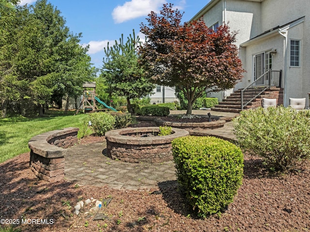 1 Hopkinson Ct, Marlboro, NJ 07746 - view of green lawn with an outdoor fire pit and a playground