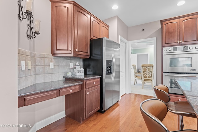 1 Hopkinson Ct, Marlboro, NJ 07746 - kitchen with appliances with stainless steel finishes, light wood finished floors, and dark stone countertops