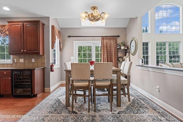 1 Hopkinson Ct, Marlboro, NJ 07746 - dining space with beverage cooler, a chandelier, wood finished floors, and recessed lighting