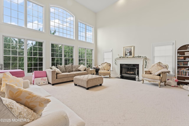 1 Hopkinson Ct, Marlboro, NJ 07746 - living area featuring a high ceiling, a fireplace with flush hearth, and carpet