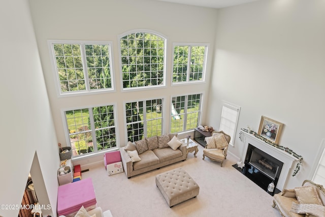 1 Hopkinson Ct, Marlboro, NJ 07746 - carpeted living area featuring a high ceiling, plenty of natural light, and a fireplace with flush hearth