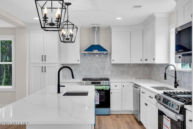 629 Monmouth Ave, Toms River, NJ 08757 - kitchen featuring stainless steel appliances, a chandelier, ventilation hood, white cabinetry, and recessed lighting